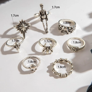 Close-up of 8-piece gothic ring set showing skull, spider, and star motifs with size labels
