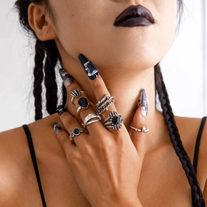 Gothic punk ring set featuring heart ruby and skeleton claw details on hand
