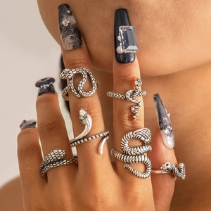 Set of vintage silver snake rings featuring punk serpentine designs on fingers