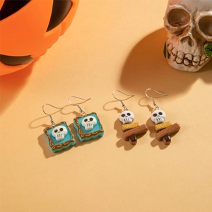 Halloween skull and Happy Halloween sign earrings on festive orange background