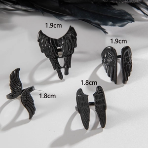 Gothic black angel wing ring set with four punk style feather rings in dark aesthetic