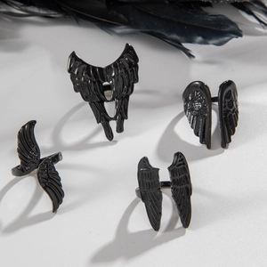 Gothic black angel wing ring set with four punk feather styles on white background