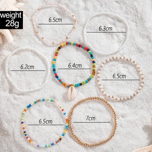 Detail of 7-piece bohemian anklet set with colorful beads, shells, and size measurements