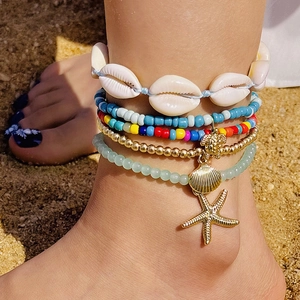 Detail of bohemian beach anklet set featuring colorful beads, shells and starfish charms