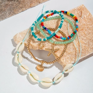Detail of 5-piece Bohemian anklet set with sea shell, starfish and turtle charms