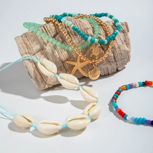 Detail of bohemian beach anklet set featuring colorful beads and starfish shell charms