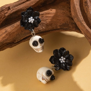 Gothic Halloween skull earrings featuring black camellia flowers and white pearls