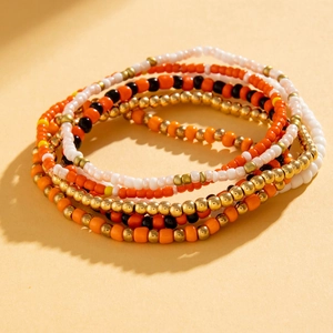Detail of colorful Bohemian beaded anklets with starfish and shell accents for beach style