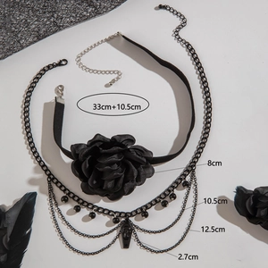 Gothic black lace rose choker with layered chains and coffin pendant on white background