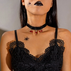 Close-up of gothic lace choker with black spider web patterns and red teardrop pendants