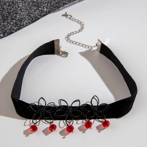 Macro detail of Gothic black lace choker with red crystals and adjustable silver chain