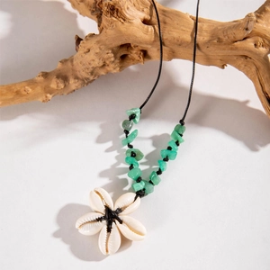 Close-up of bohemian shell star pendant necklace with natural green turquoise stones