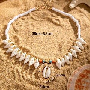 Detail shot of a bohemian shell necklace with starfish accents on a golden sandy beach