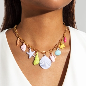 Detail of colorful seashell and starfish pendants on a gold bohemian necklace for women