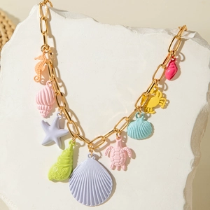 Detailed close-up of gold chunky chain with vibrant enamel sea creature pendants