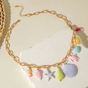 Detail of colorful starfish and seashell charms on a gold bohemian style necklace