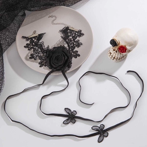 Gothic black lace choker with large rose and butterfly ribbons in dark aesthetic setting