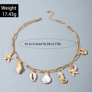 Detail of bohemian necklace with starfish, seahorse and shells on paperclip chain