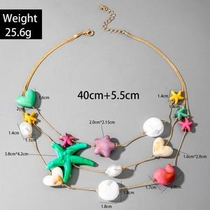 Detail of bohemian shell necklace showing 40cm chain with colorful starfish charms