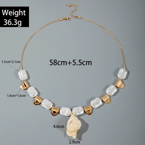 Detail view of Bohemian shell necklace with starfish pendant and baroque pearl accents