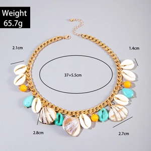 Detailed view of bohemian gold chain necklace with white shells and turquoise beads