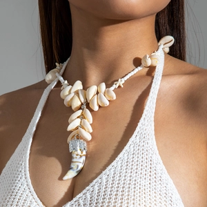 Detail view of shell necklace with starfish accents and unique layered horn pendant