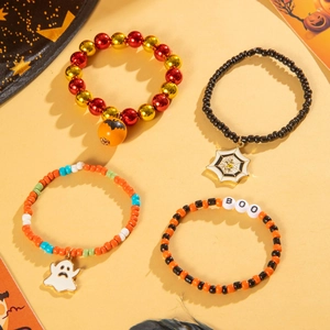 Detail of four Halloween beaded bracelets featuring pumpkin, ghost, and spider charms