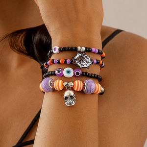 Detail of Halloween beaded bracelet set featuring skull charms and devil eye accents