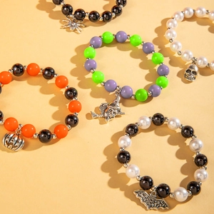 Detail view of 5-piece Halloween beaded bracelet set with pumpkin and skull charms