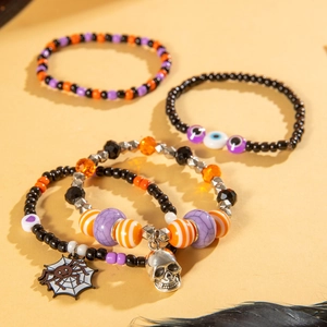 Halloween beaded bracelet set featuring skull and evil eye charms in orange and black