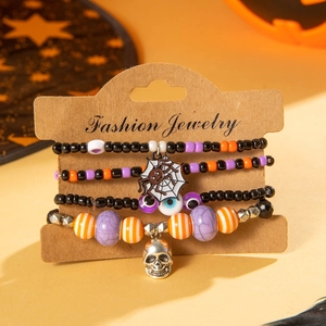 Halloween beaded bracelet set with skull, spider web, and evil eye charms on card