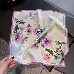 Detailed macro view showing the soft satin luster and floral print of this silk square scarf
