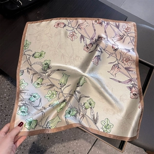 Detail showing high-quality silk scarf texture with bellflower print and satin finish