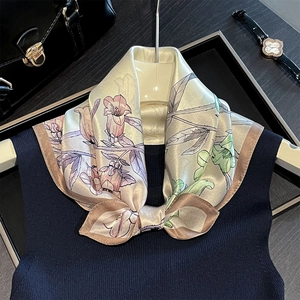 Close-up of floral print silk scarf with fine texture and elegant champagne gold sheen