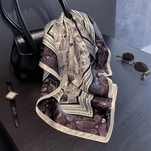 Foulard en soie aux motifs marins attaché à un sac à main pour un look chic