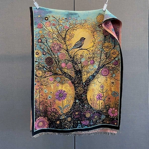 Close-up of tree of life jacquard weave and delicate fringe tassels on a woven scarf