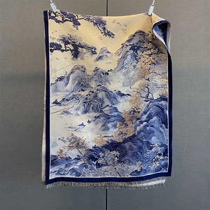 Detailed view of jacquard floral scarf with mountain landscape pattern and fringe trim