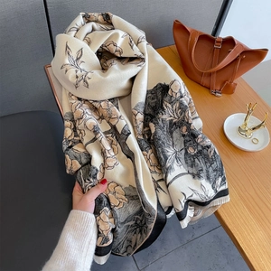 Gros plan sur écharpe jacquard florale vintage avec base beige et franges douces