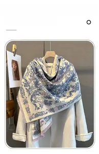 Detailed texture of imitation cashmere scarf with floral prints and pink tassels
