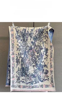 Detail of vintage flower and bird jacquard pattern with pink tassels on warm scarf