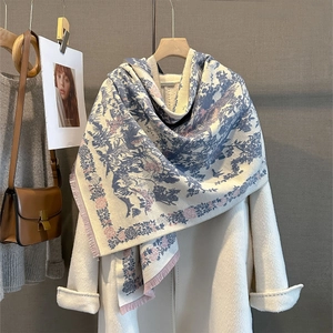 Detail showing vintage toile de jouy print and soft tassel edges on a warm winter scarf