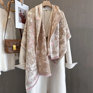 Detail of vintage flower and bird print shawl with soft fringes on beige cashmere-feel fabric