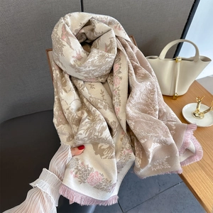 Detail of vintage Toile de Jouy floral print scarf with pink fringe on cream fabric