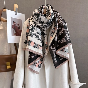 Elegant vintage floral print scarf with fringes styled on a cream coat and leather bag