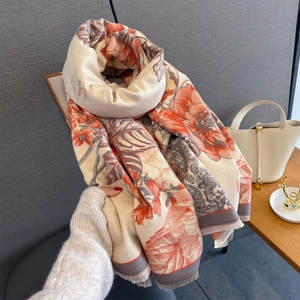 Detail of floral jacquard cashmere scarf with orange flowers and fringed edges
