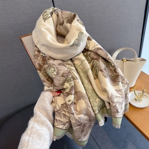 Close-up of floral and butterfly print cashmere-feel scarf with fine fringed edges