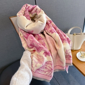 Detailed view of soft cashmere blend scarf featuring elegant pink floral jacquard and grey fringe