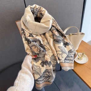 Detailed view of beige cashmere-like scarf with vintage floral prints and fine tassel edge