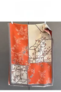 Detail of fine jacquard floral scarf showing orange patchwork texture and soft fringes