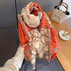 Close-up of vintage floral print scarf in orange and grey with delicate fringe detail